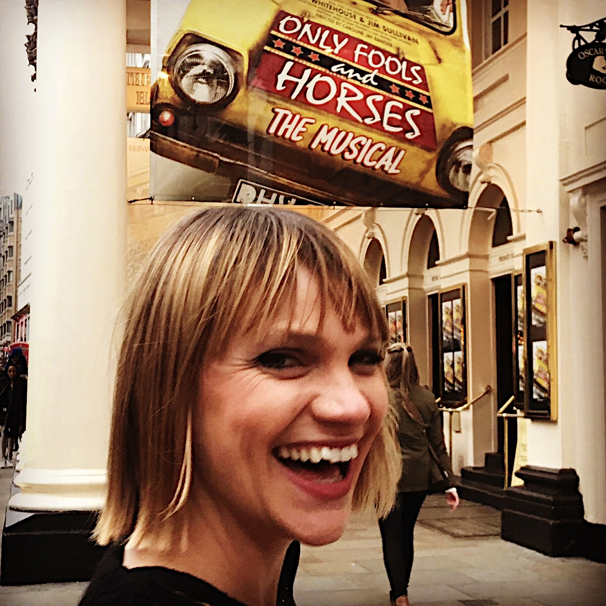 Pippa in street under sign for Only Fools and Horses