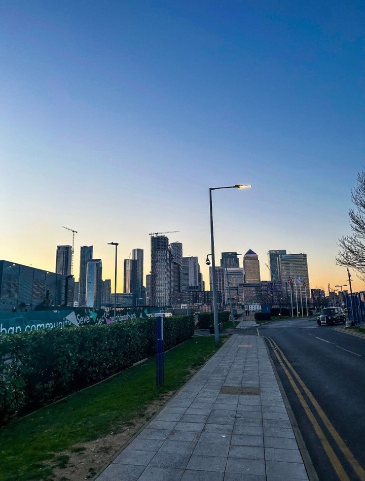 Photo of London street and tower blocks at sunset