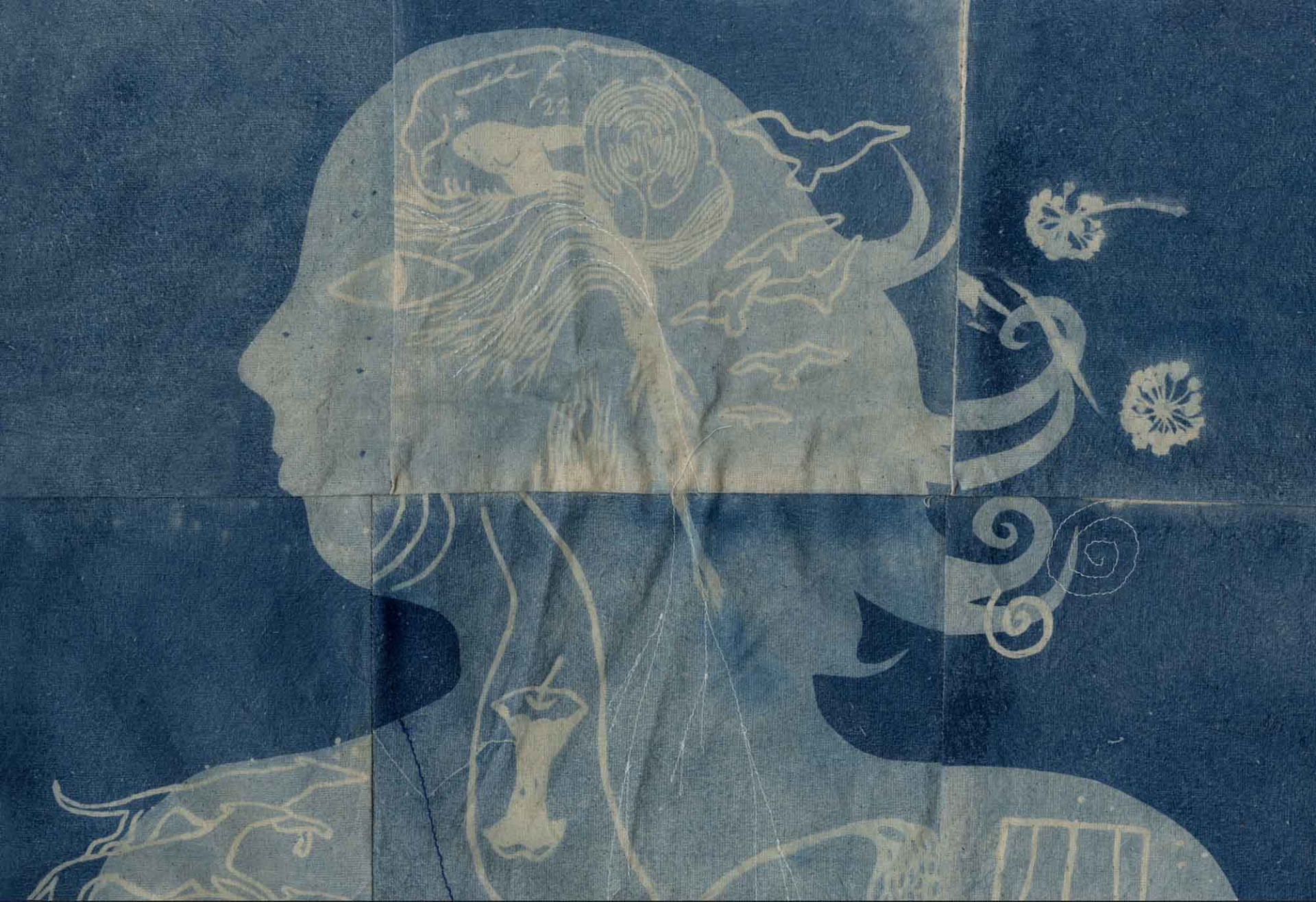 Cyanotype quilt of woman's face and interests