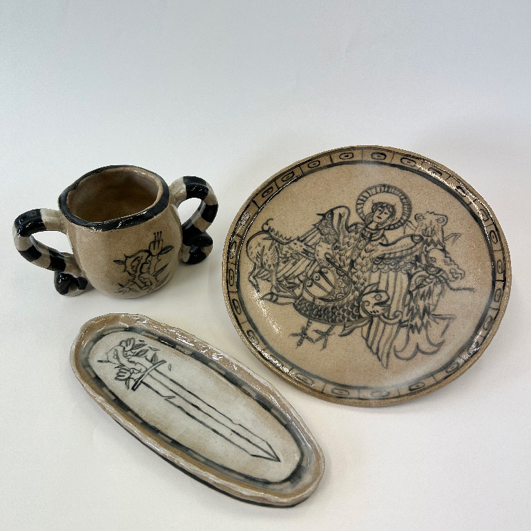 Photo of illustrated ceramic mug, plate and dish