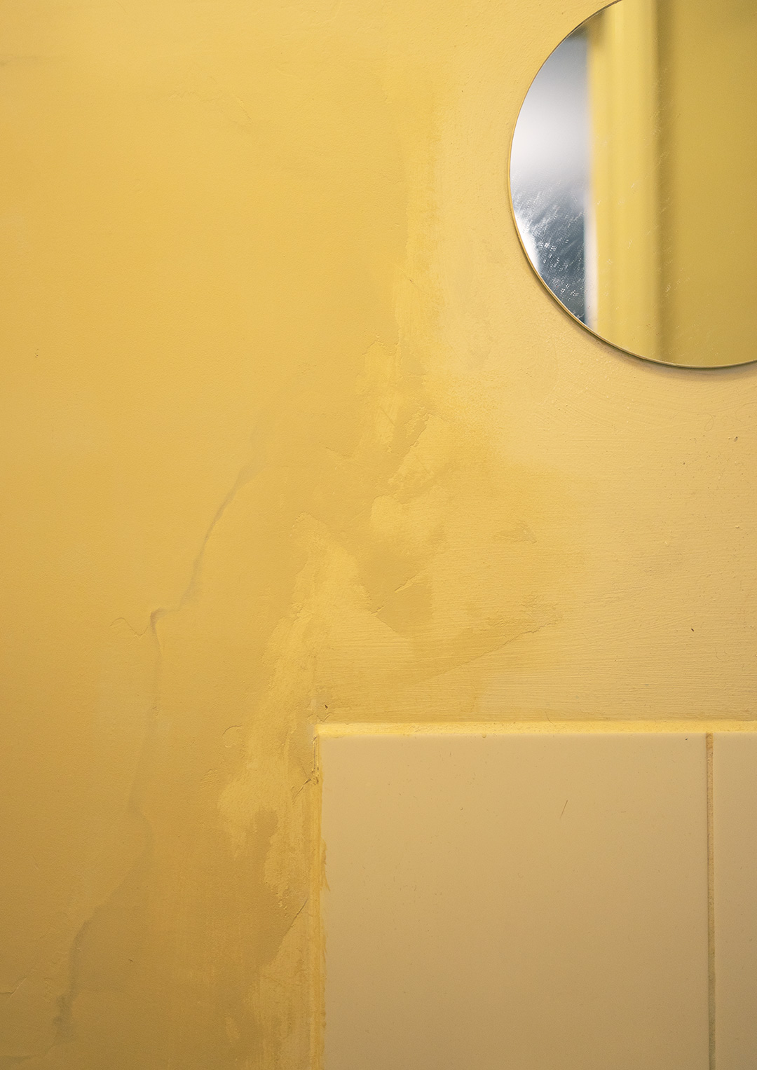 Photo of patchy paint on bathroom wall