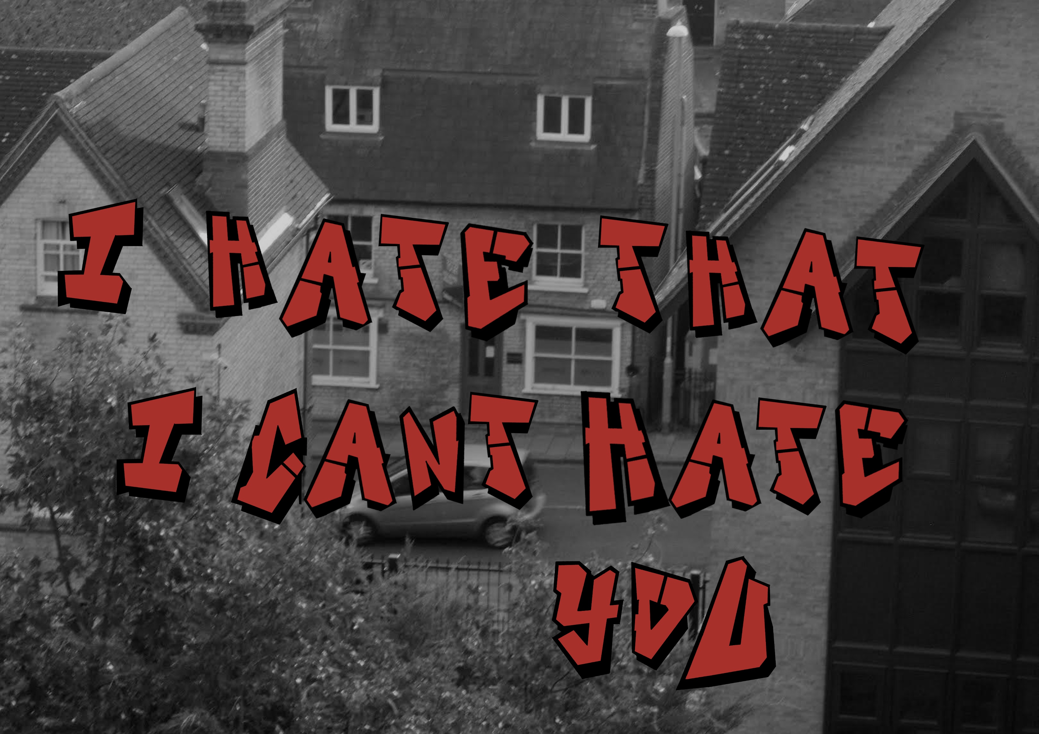 Monochrome photo of houses from above with legend “I hate that I can’t hate you”