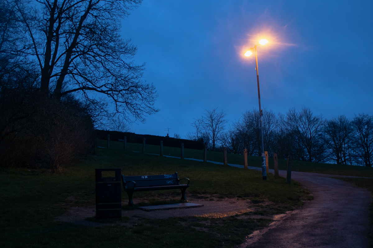 Photo of bench on hill at twilight