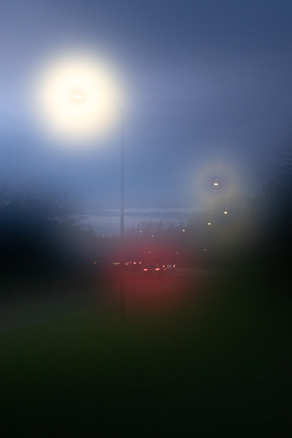 Blurred photo of cars on road under streetlights