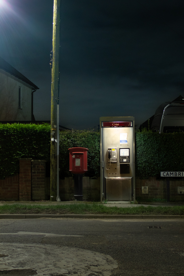 Photo of phone box next to letter box and street light
