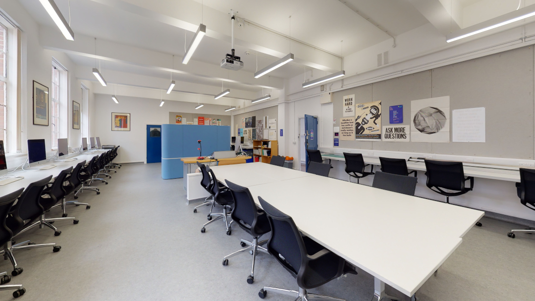 Studio with large desks and graphic design equipment and images