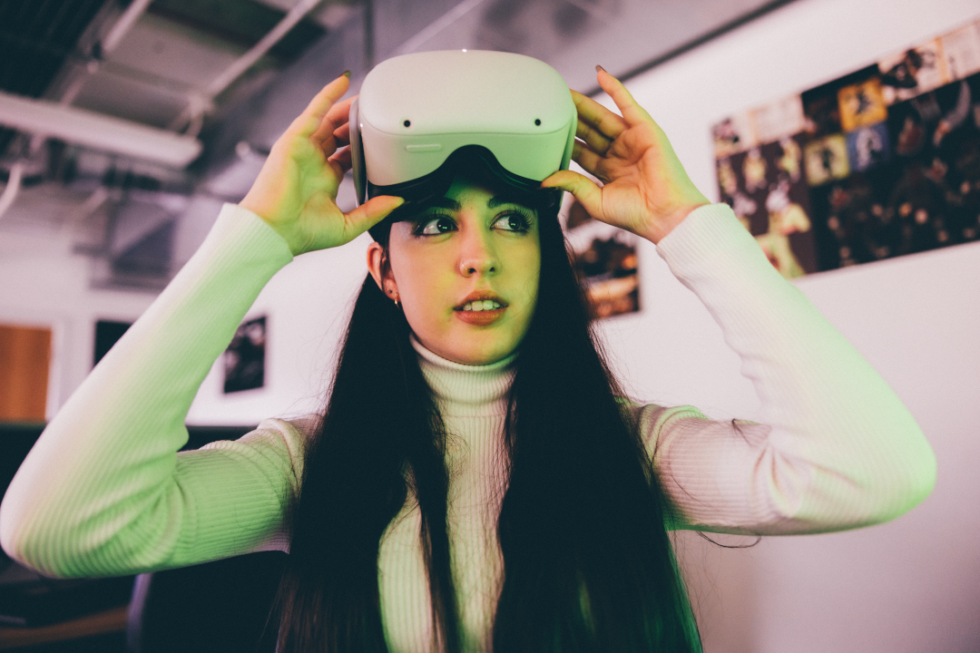 A young woman with VR goggles on head