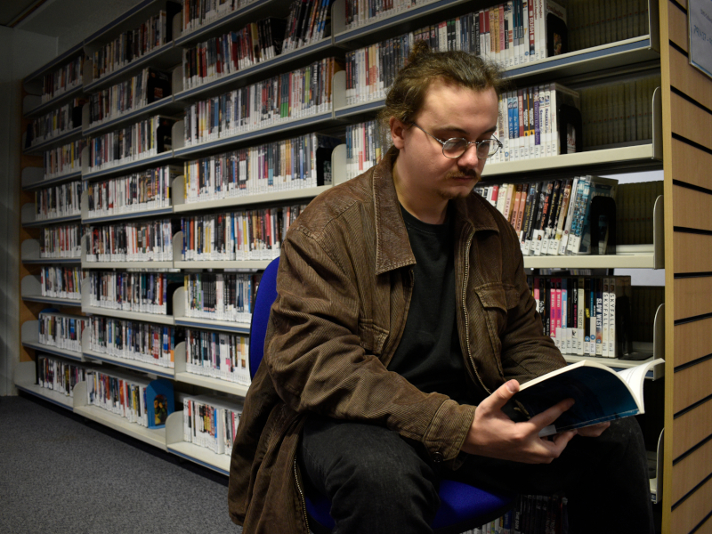 Sam Millar reading in library