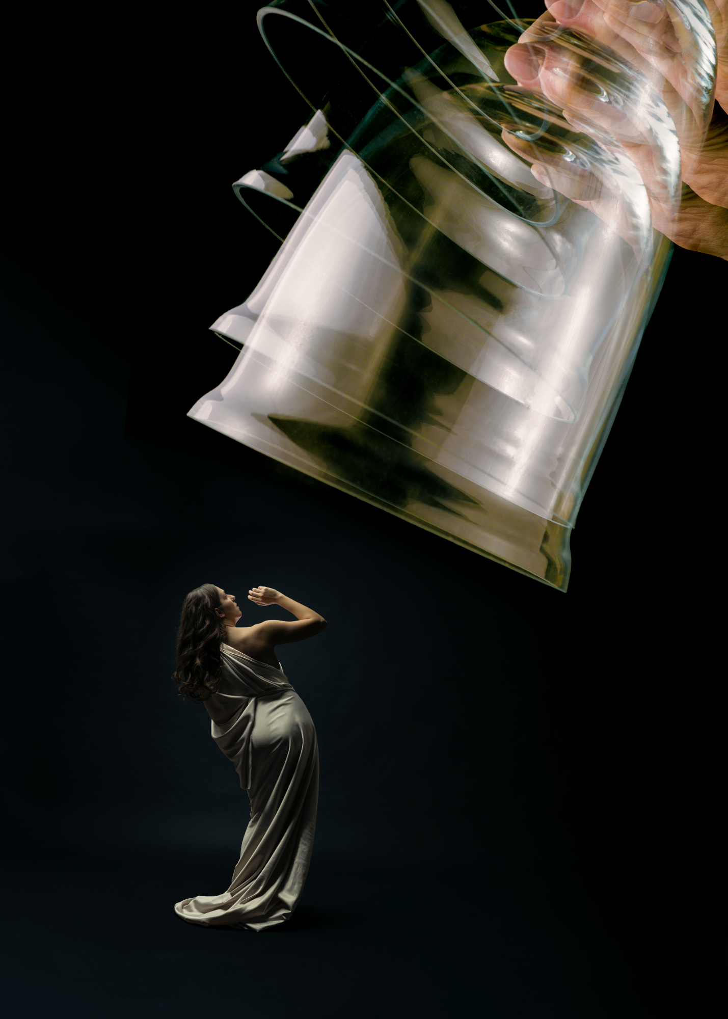 Photo of bell jar being lowered onto woman in white gown