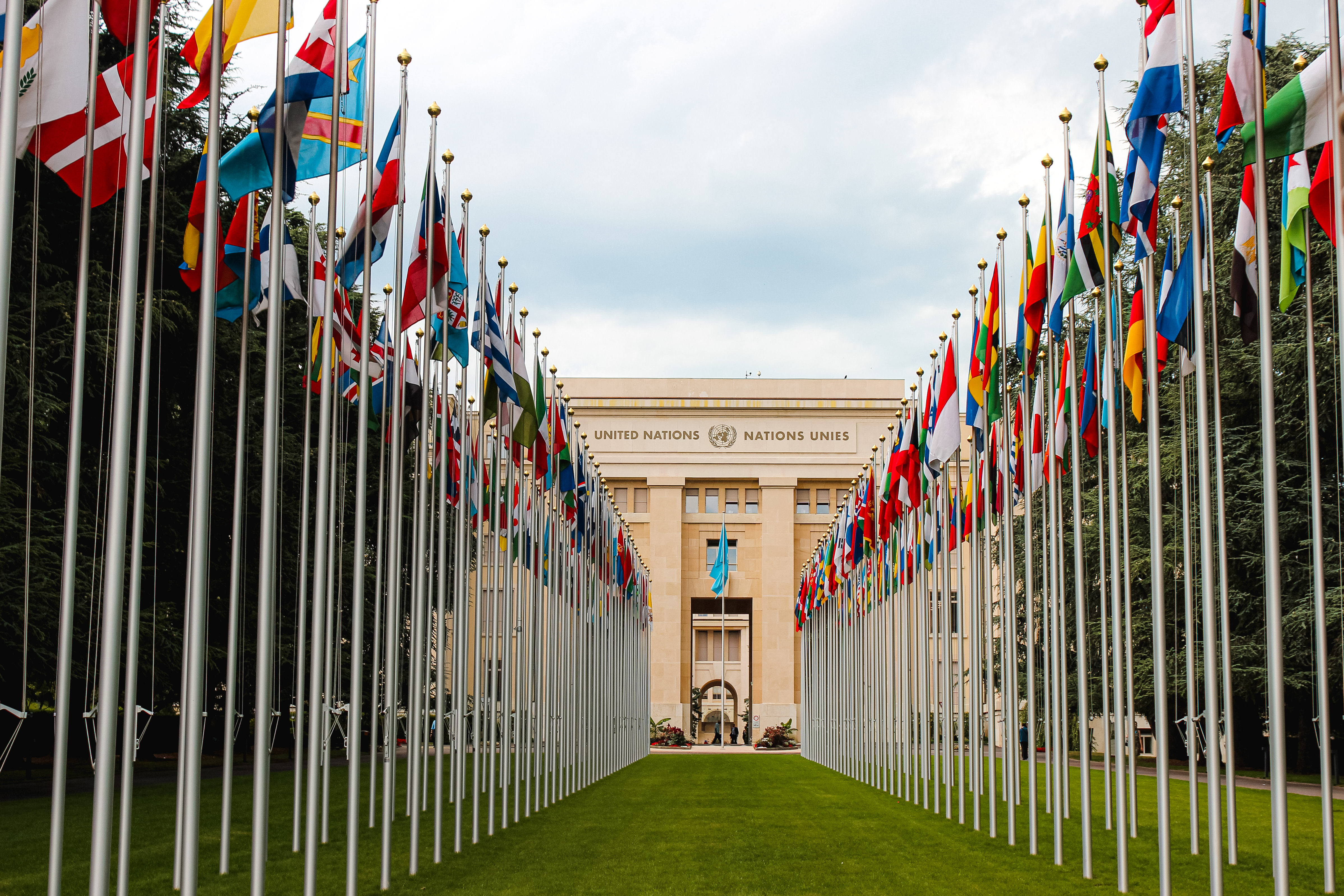 View of the United Nations Geneva building flanked by the flags of the countries belonging to the United Nations