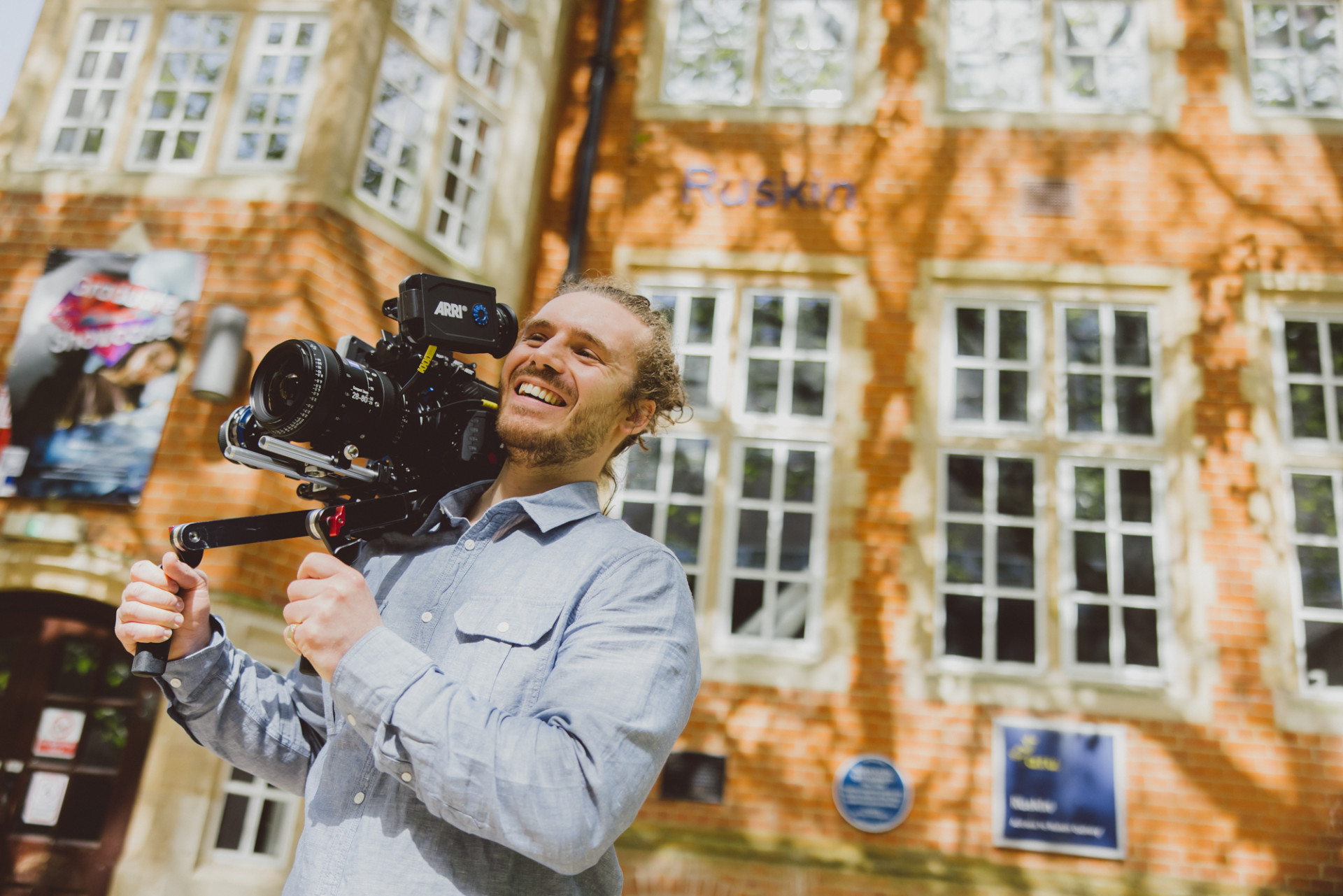 Man holding Arri Alexa camera outside Ruskin Building, Cambridge