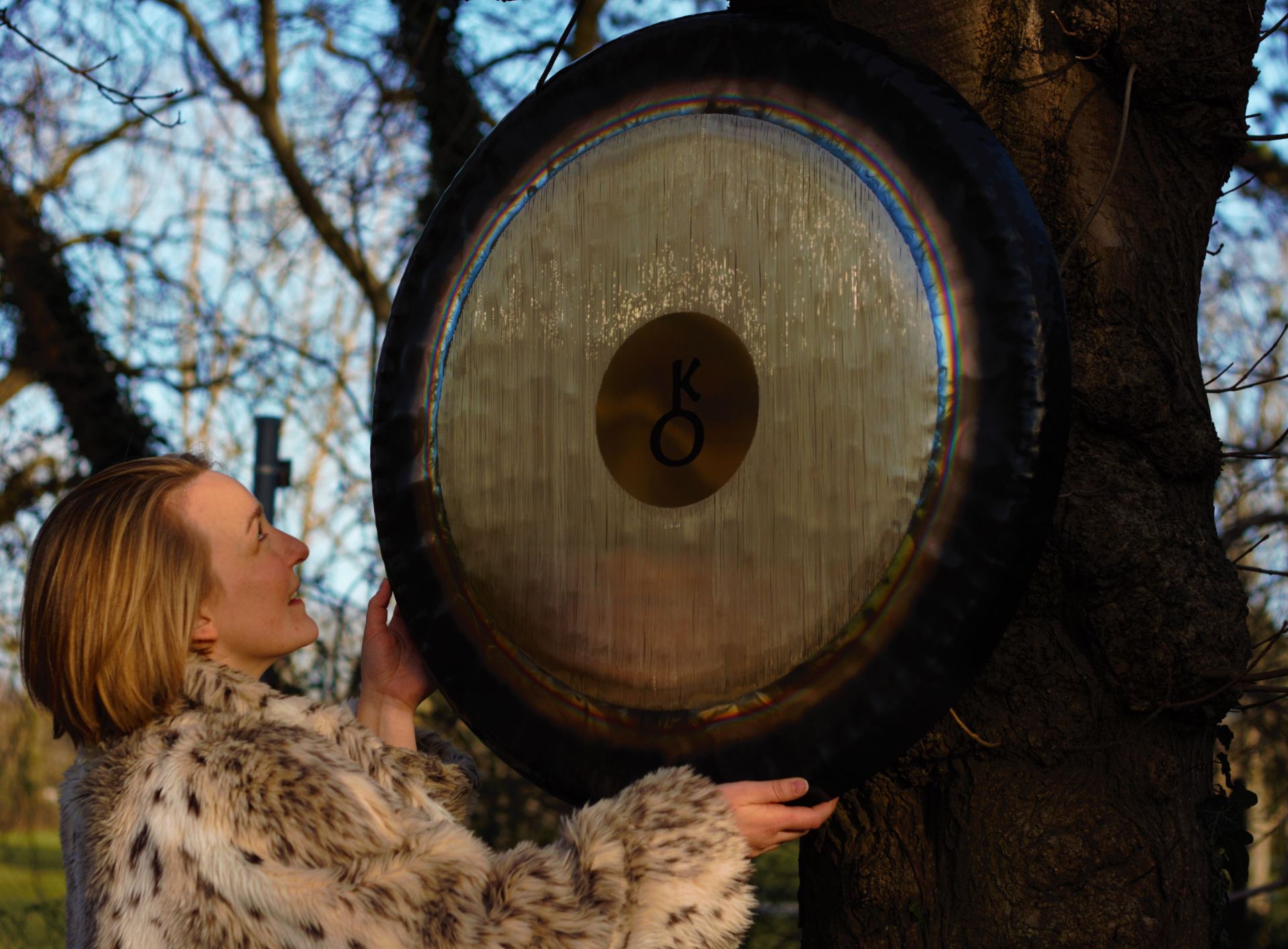 Claire White positioning gong on tree