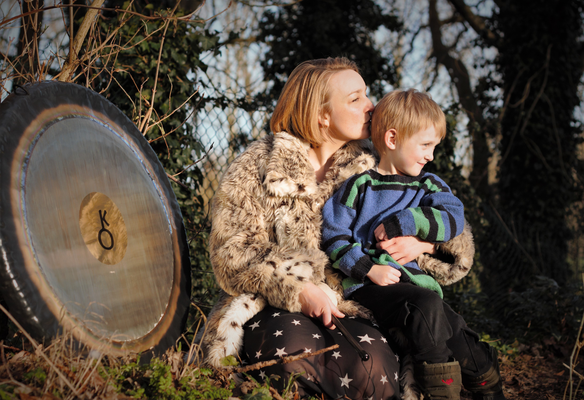Calire White and her son with a gong outside