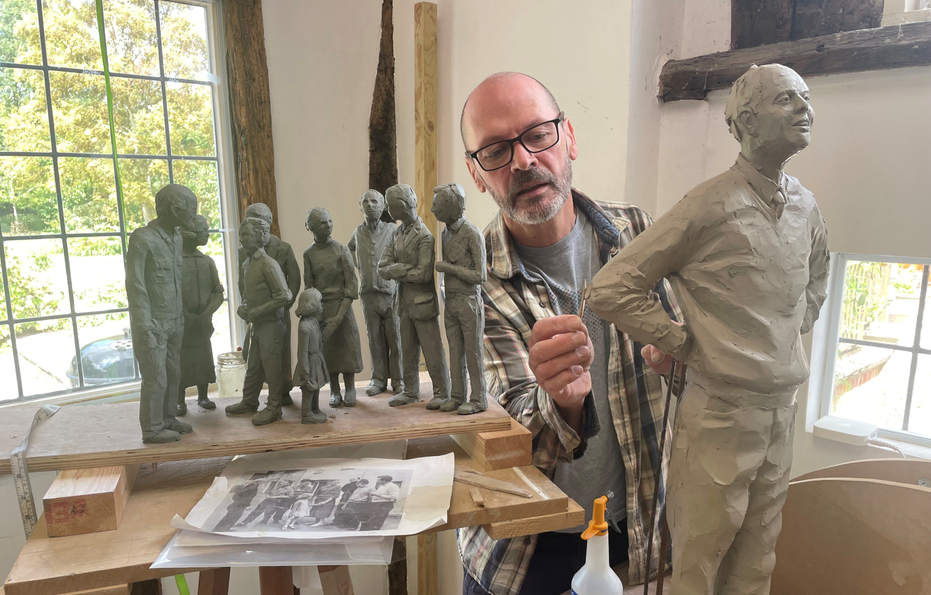 Ian Wolter working on sculptures of people
