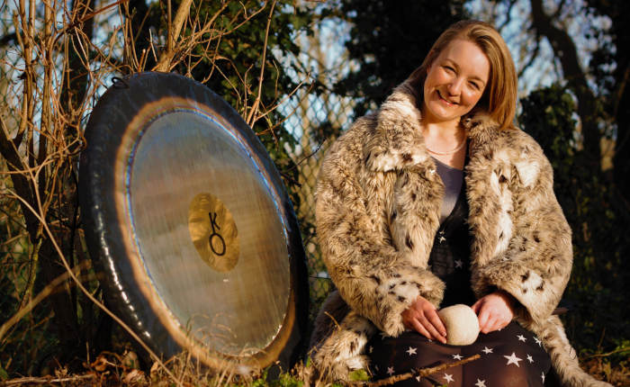 Claire White with a gong outside
