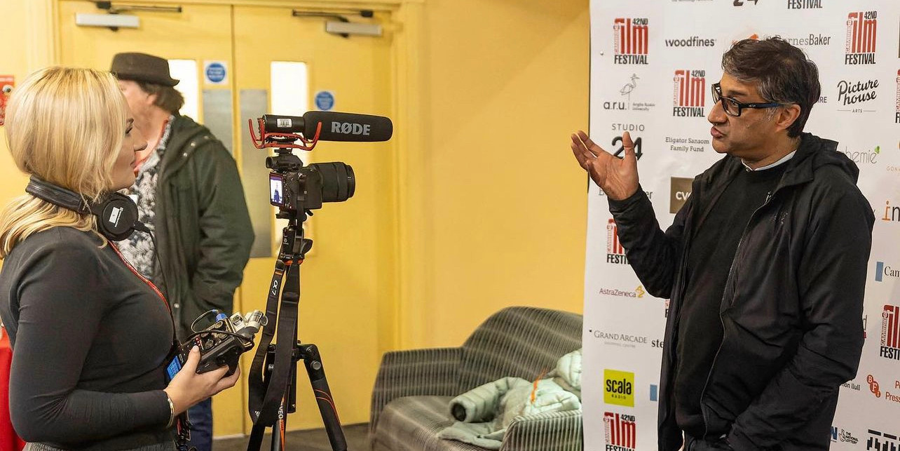 Megan conducting video interview with man at Cambridge Film Festival