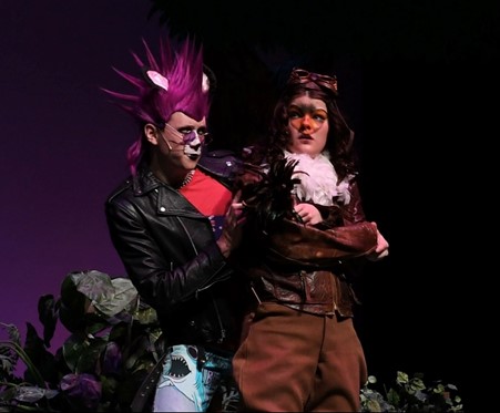 Trey Augustus on stage in punk cat costume with female actor