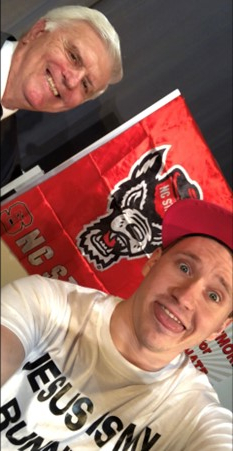 Trey Augustus pulling face in front of NC State banner
