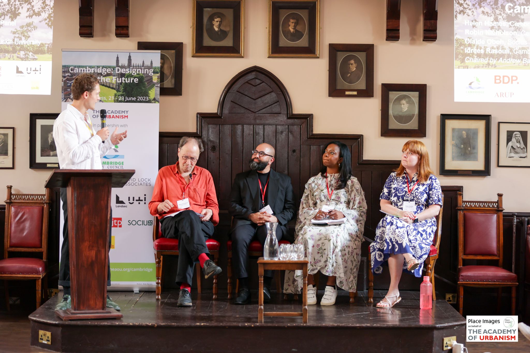 Idrees Rasouli sitting on panel at event in church
