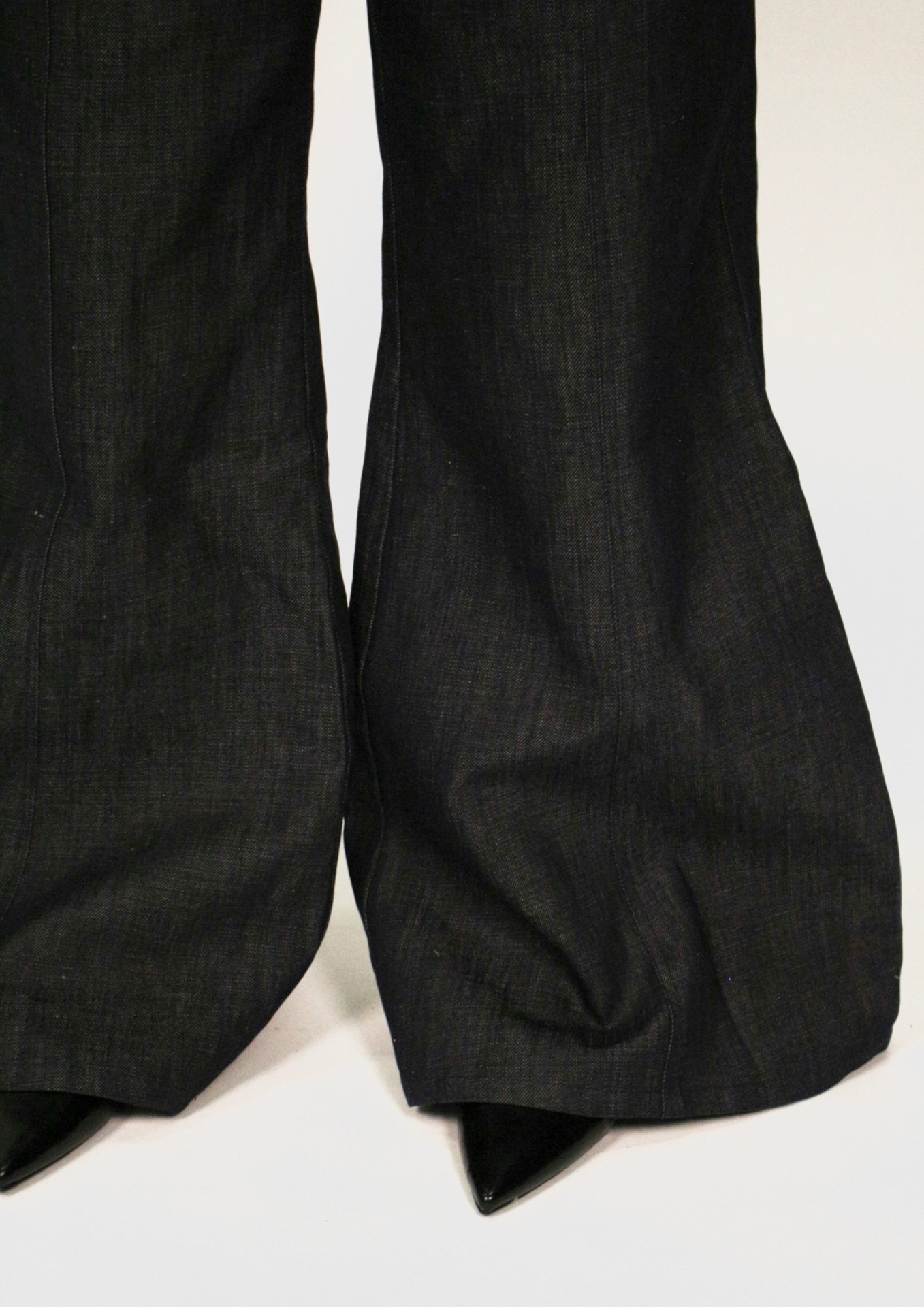 Bottom of flared charcoal trouser legs