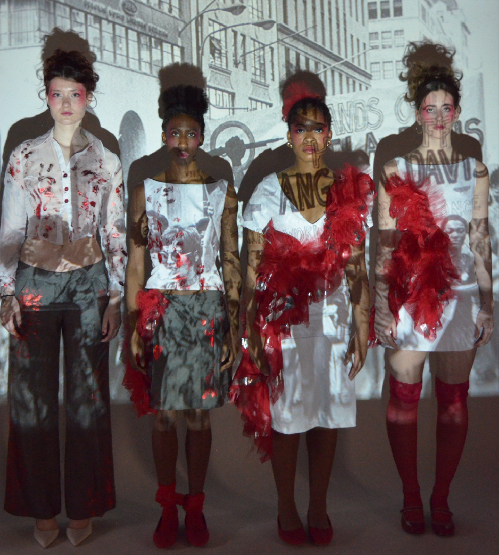 Four female models in red, white and grey outfits splashed with red smears and handprints