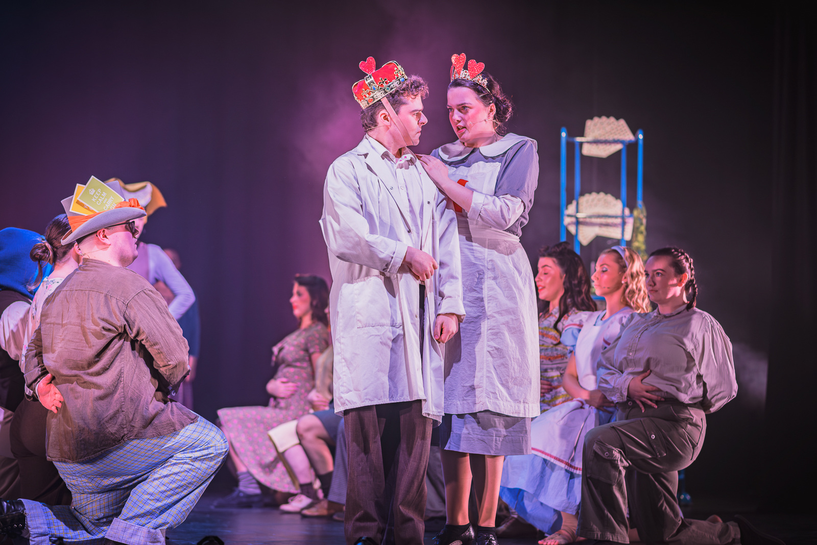 The King and Queen of Hearts, surrounded by other cast members