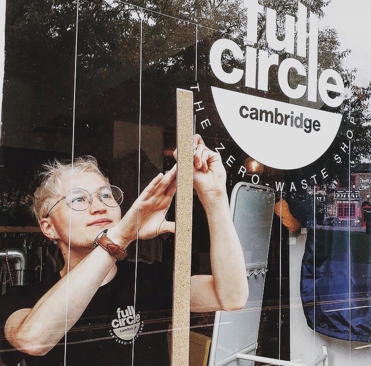 ARU student Jay Wright pictured applying a new window stick in Full Circle Cafe.