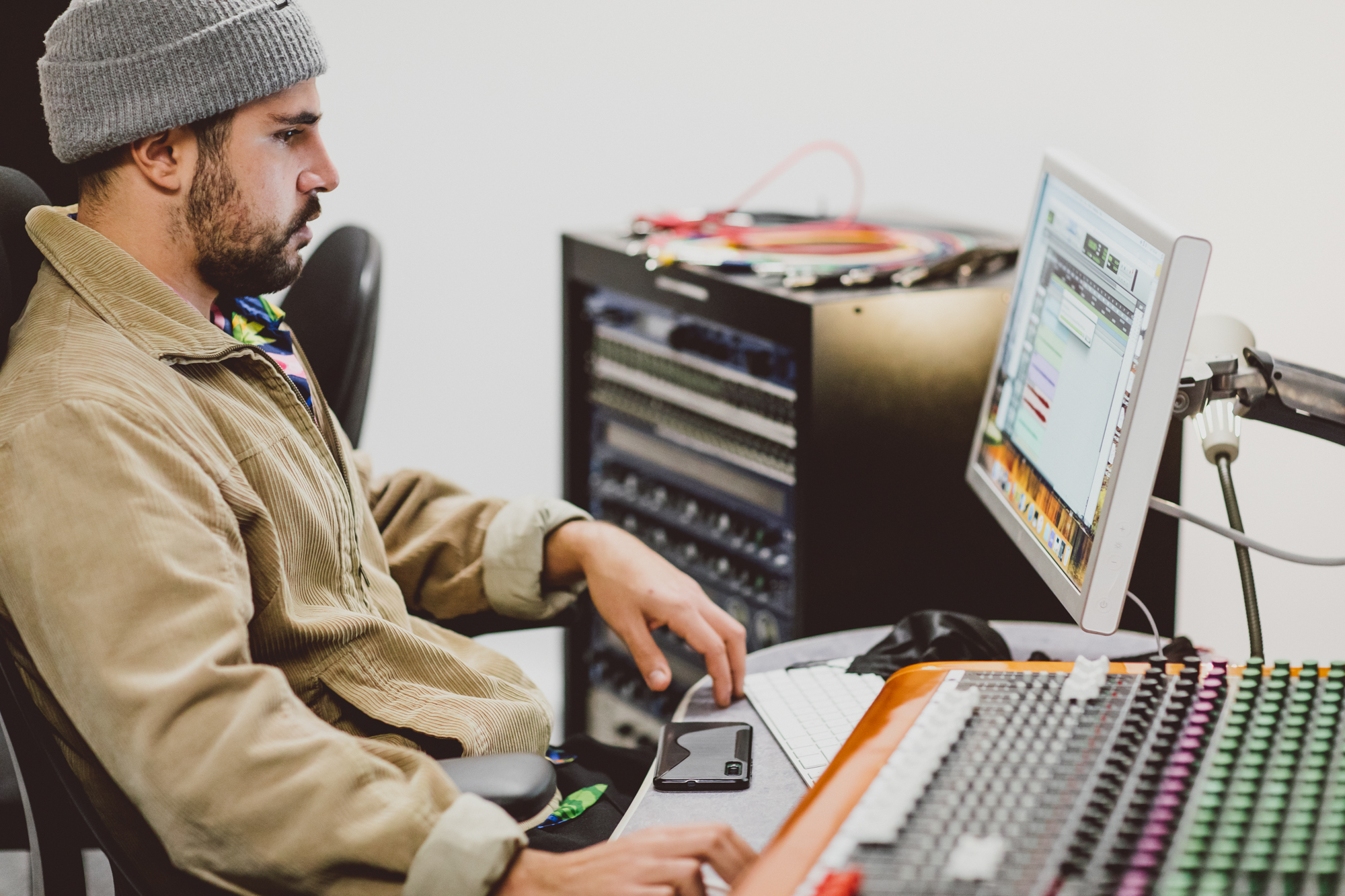 Student using mixing desk in Recording Studio 2