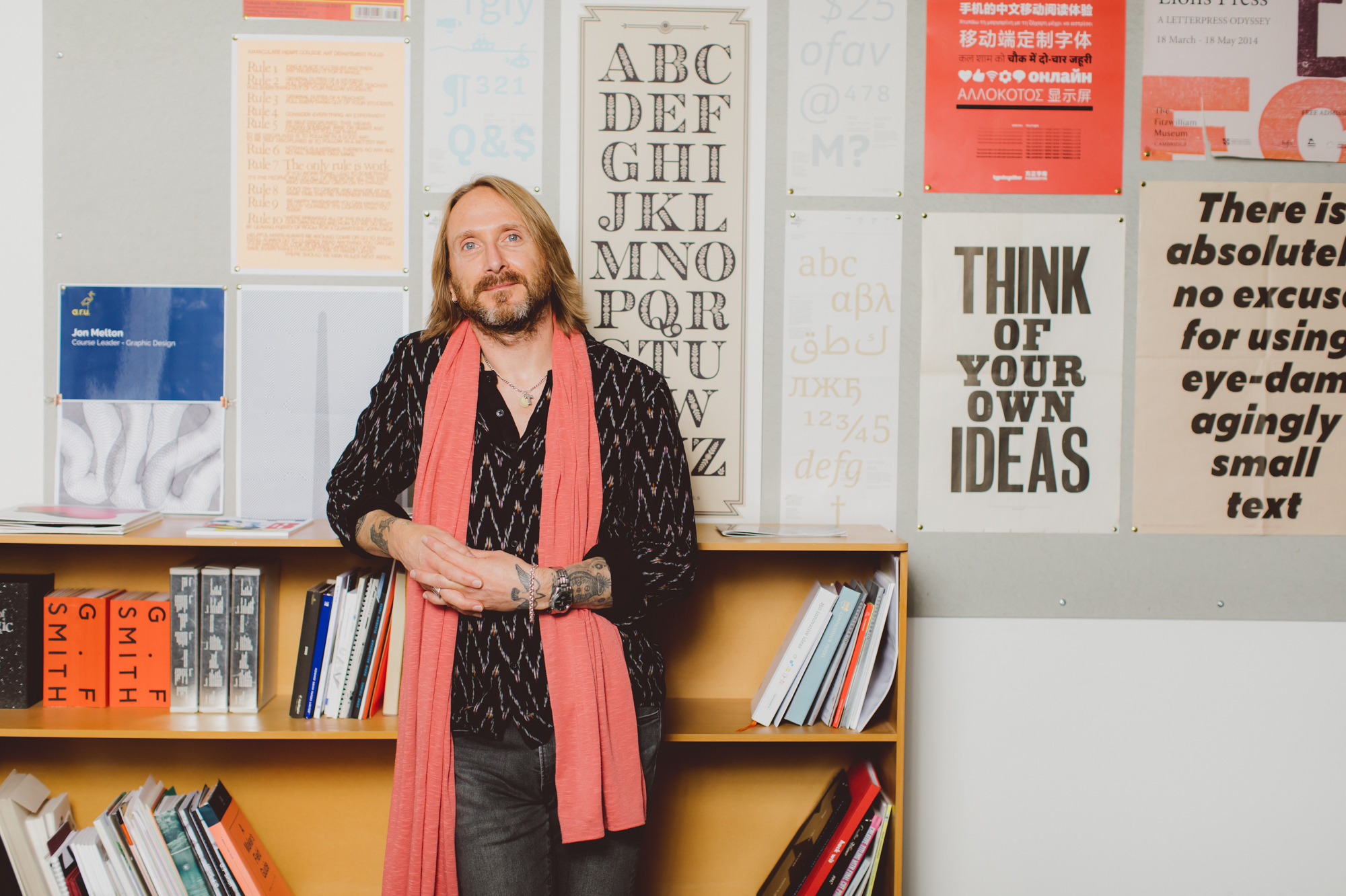 Graphic Design lecturer Nick Jeeves leaning against a shelf in a studio