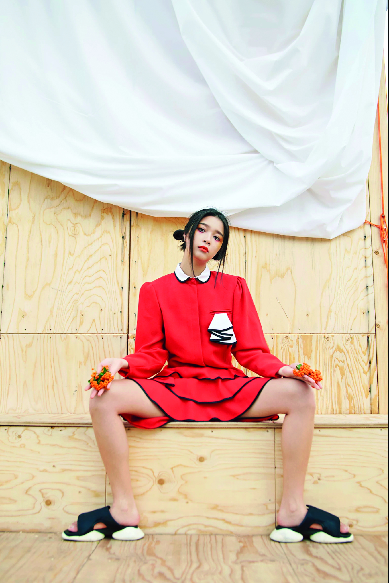 Female model wearing red top and skirt