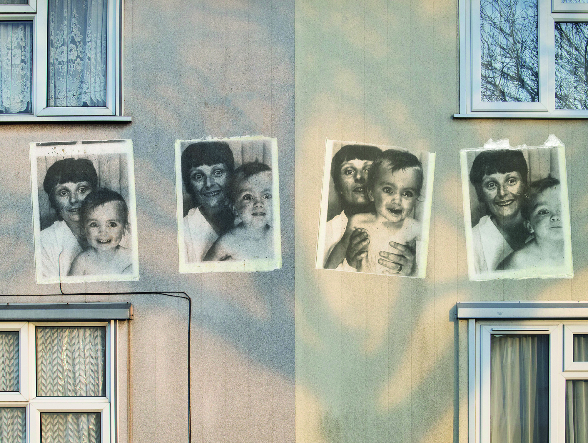 Black and white photos of Mum and baby on wall of house