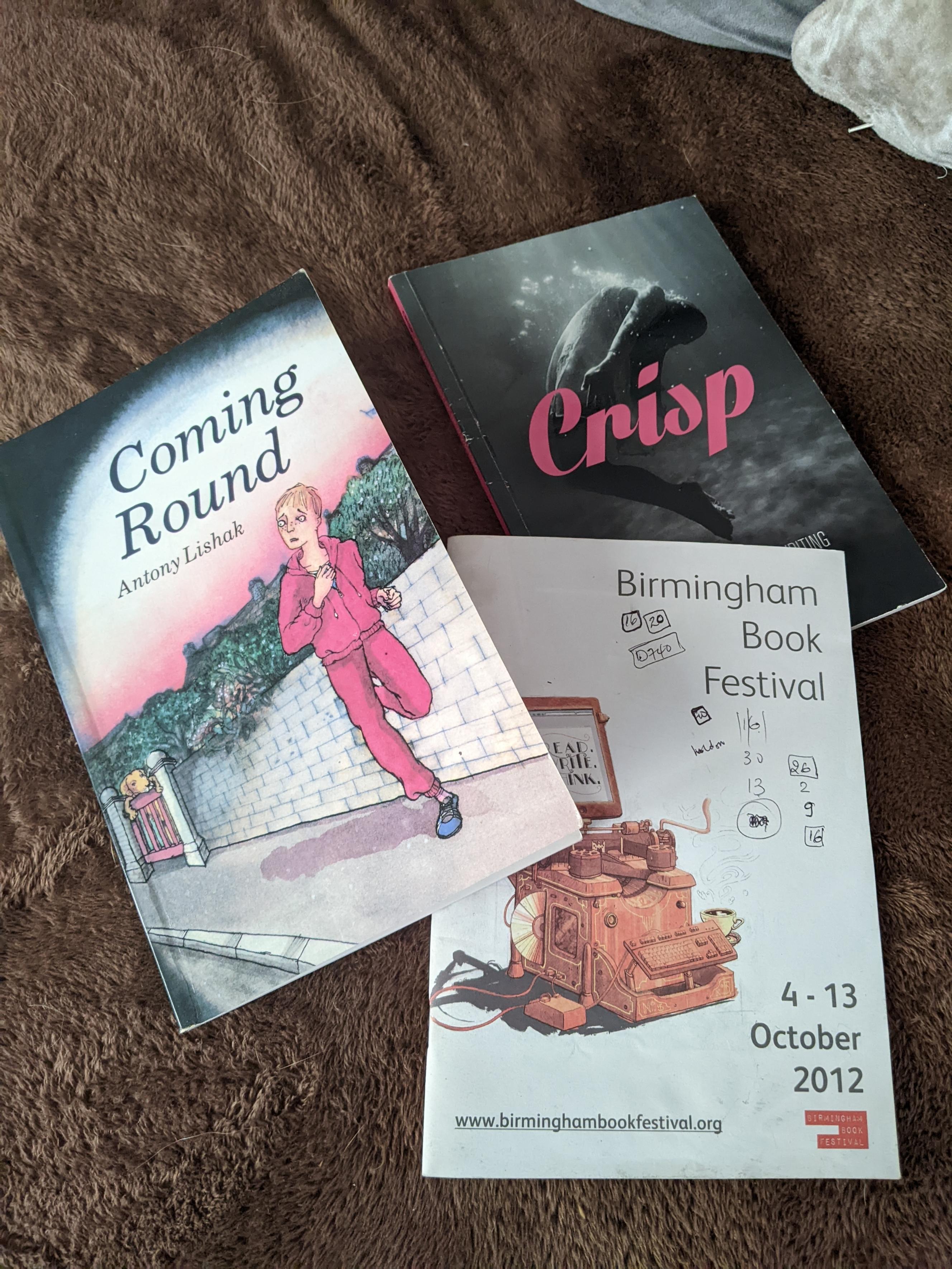 Photo of 3 books: Coming Round by Anthony Lishak, Birmingham Book Festival programme and Crisp anthology