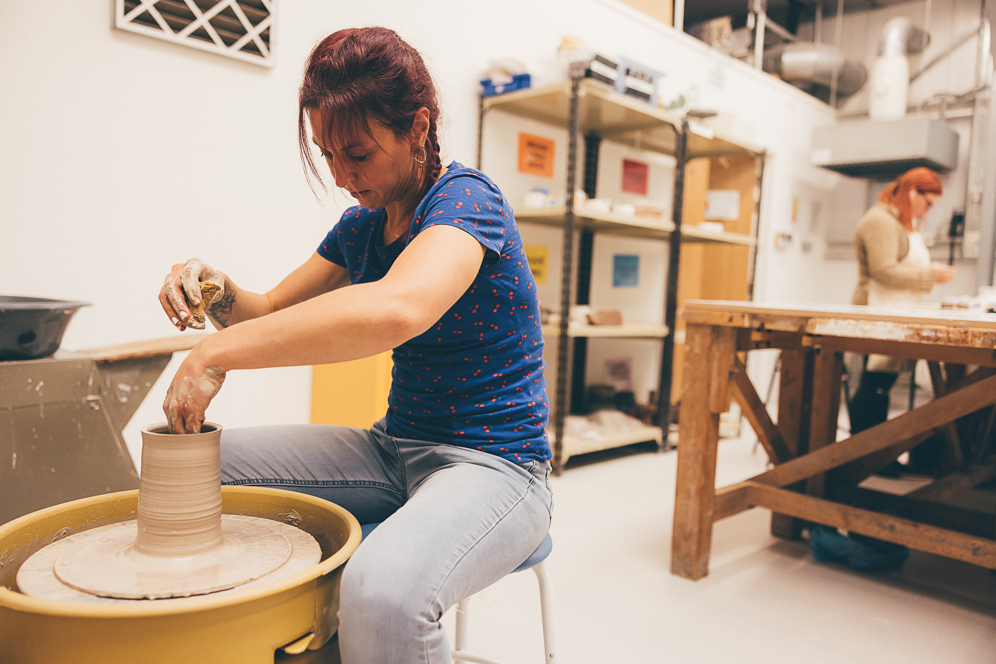 Female technician using potter's wheel