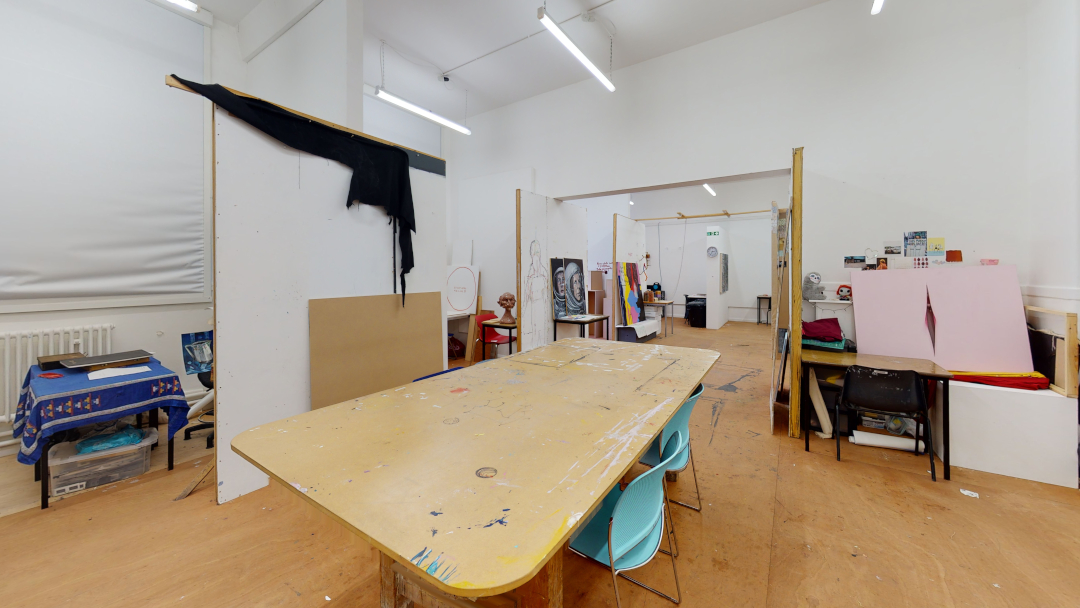 Studio space with large desk and fine art equipment
