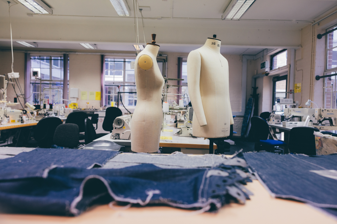 Fashion workshop with materials, sewing machines and mannequins