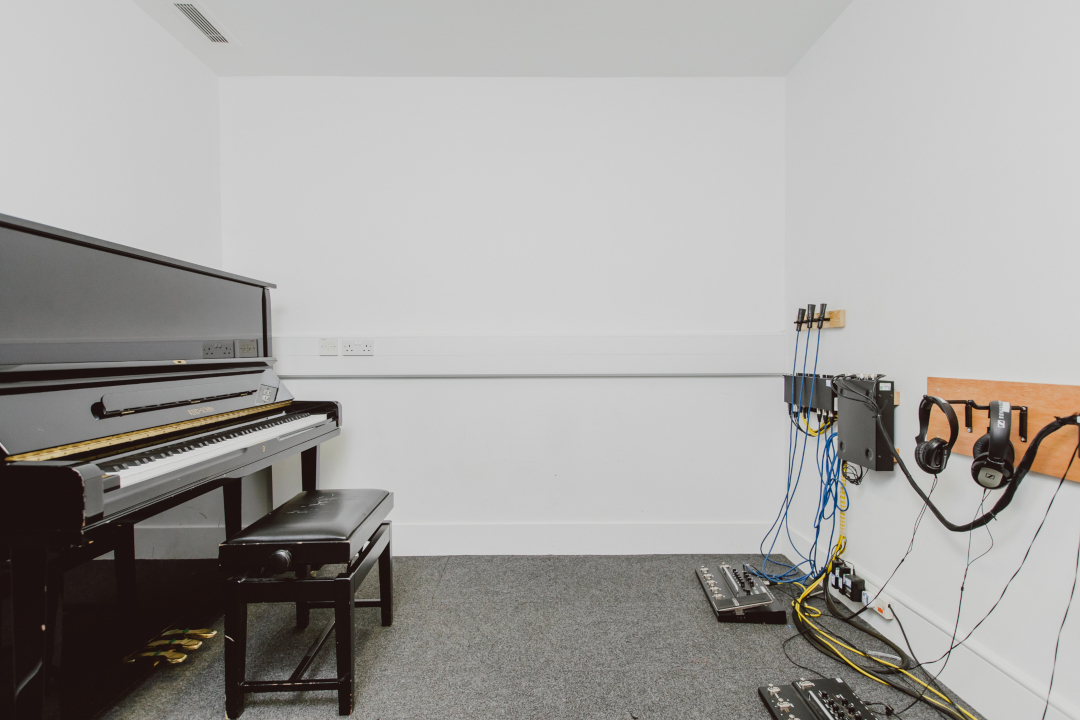Piano and other equipment in rehearsal room