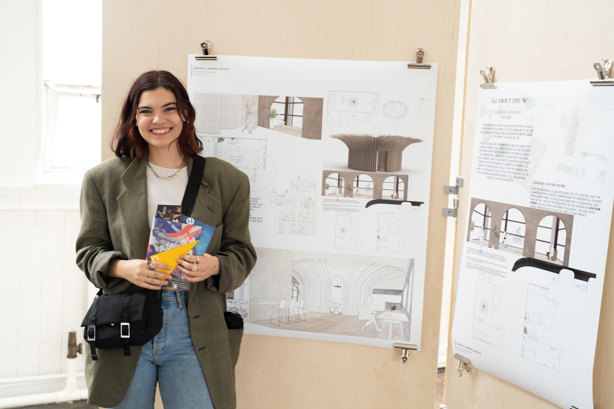 A young woman next to building design drawings