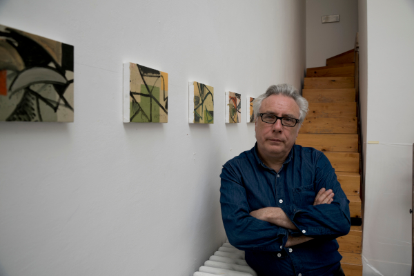 David Ryan next to artworks